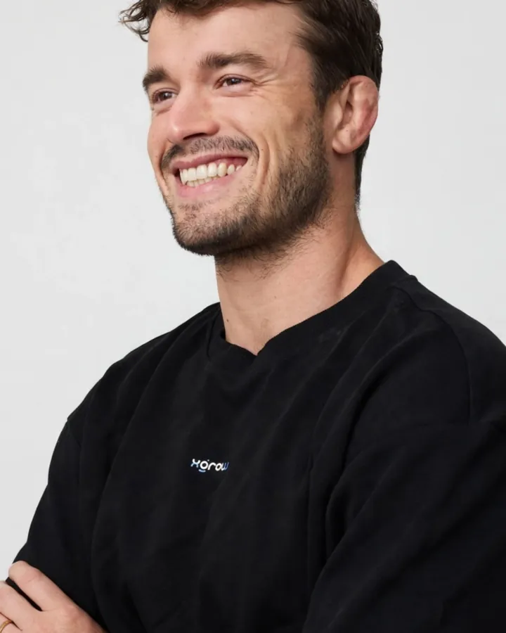 Matheus Bessa, founder of XGROW, laughing in an XGROW t-shirt